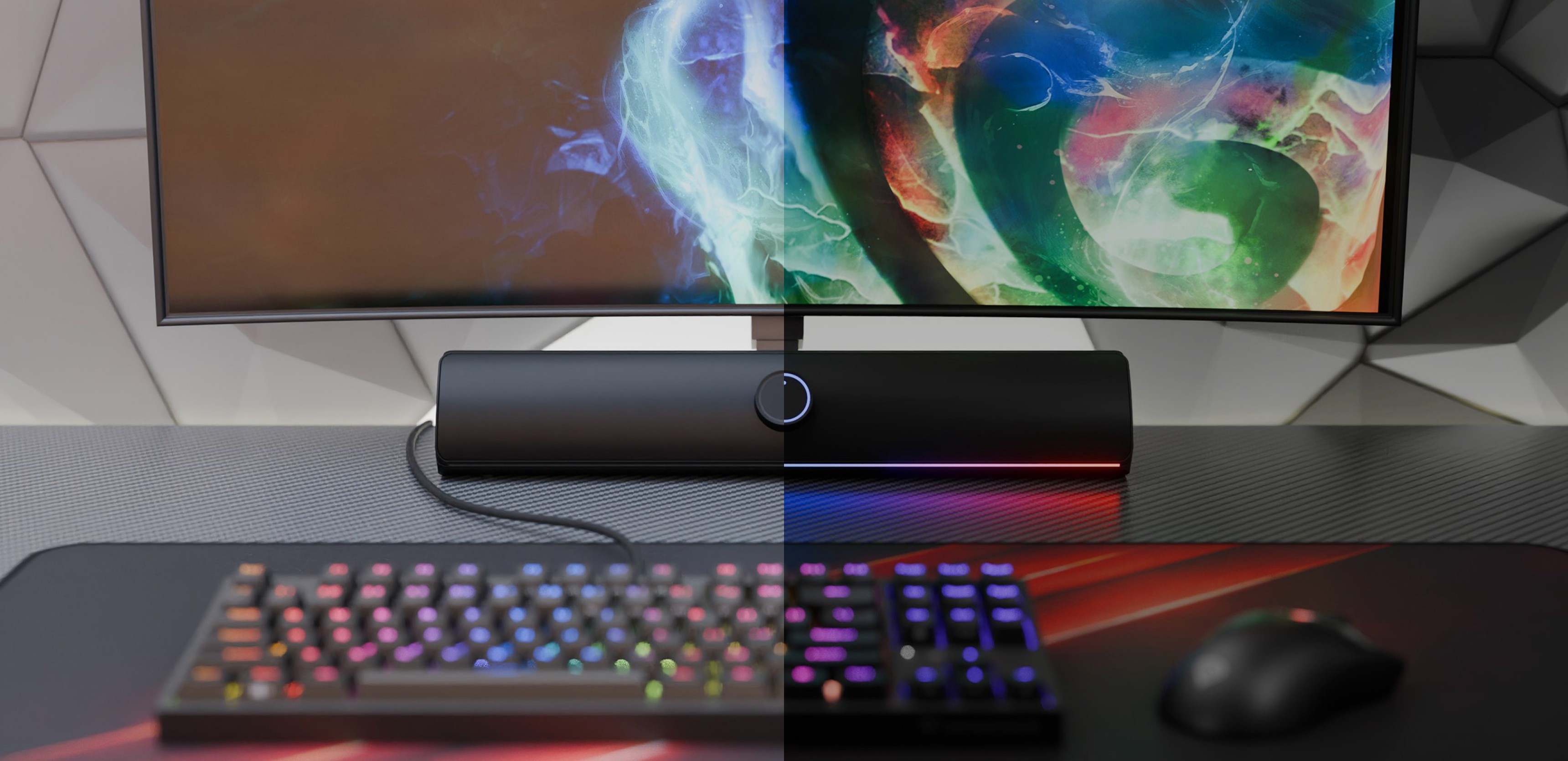 Schwarze Bluetooth-Soundbar unter einem bunten Monitor, mit RGB-Gaming-Tastatur und -Maus auf einem Schreibtisch