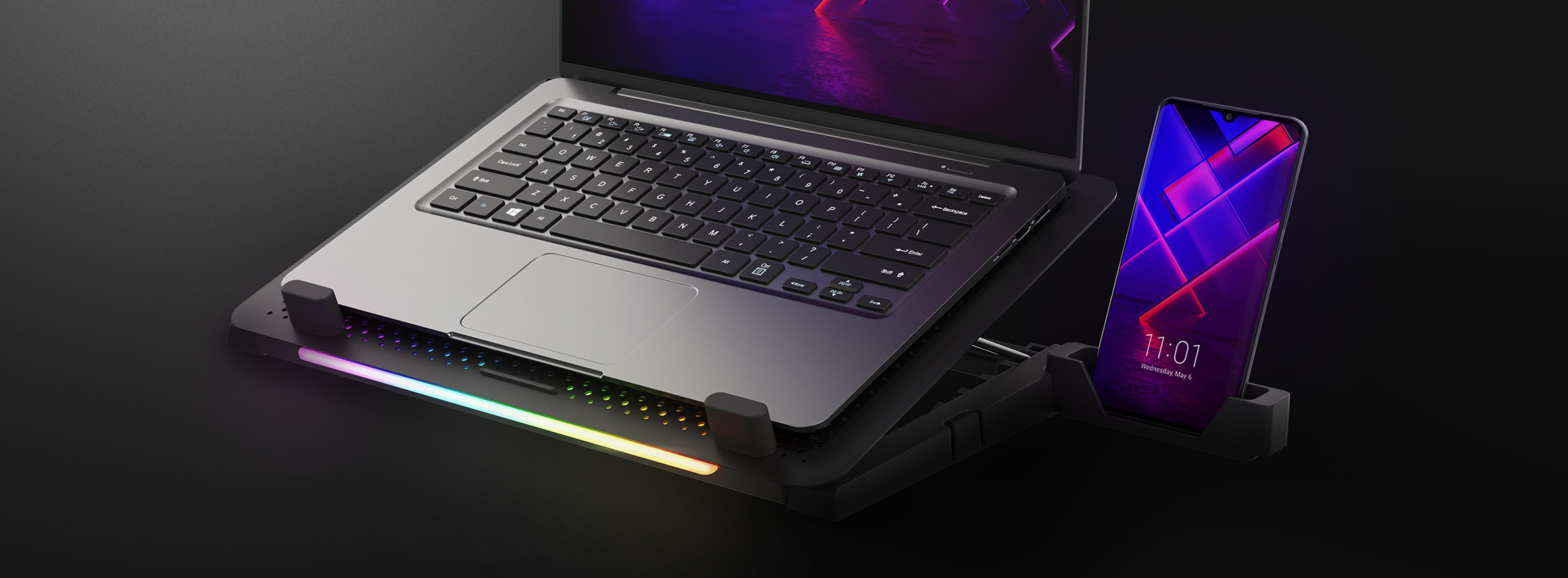 Kühlender Laptop-Ständer Genesis Oxid 450 mit RGB-Beleuchtung, einem Ventilator und zwei USB-Anschlüssen, an dem ein Laptop und ein Smartphone befestigt werden können